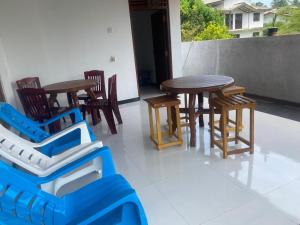 a group of chairs and tables and a table at Sedasi Holiday Home in Tangalle +30 photos