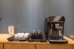a coffee maker sitting on top of a table with a laptop at Gran Suite Darsena deluxe in Isola Sacra