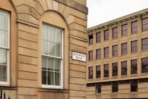 a street sign on the side of a building at Moment Blythswood St in Glasgow