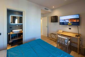 a bedroom with a bed and a bathroom with a sink at Gran Suite Darsena in Isola Sacra