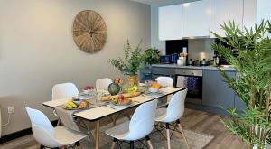 a dining room with a table and white chairs at Aspen - Airport & City Access in Dublin