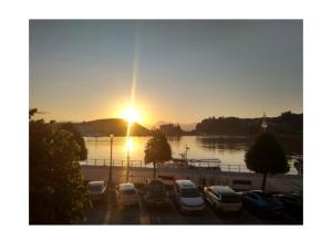 a group of cars parked in a parking lot at sunset at alojamiento Premium Ribadesella Vistas al Mar in Ribadesella