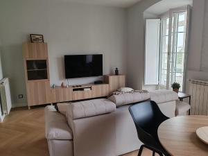 a living room with two couches and a flat screen tv at alojamiento Premium Ribadesella Vistas al Mar in Ribadesella