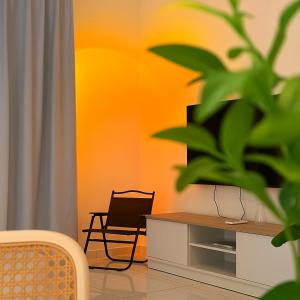 a living room with a tv and a chair at The Sun Executive Suite - Dolphin's Home in Bayan Lepas