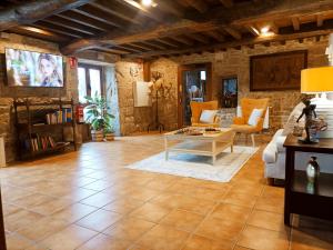 a living room with a couch and a table at Hotel Vila As Pedras in Roxos