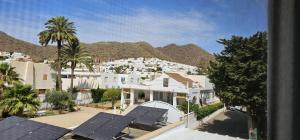 a view of a city with white houses and palm trees at Apartamentos Wily y Mavi in San José