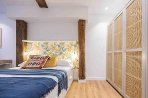 Un dormitorio con una cama y una ventana grande. en Plaza Nueva, en Bilbao