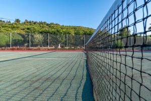 a tennis net on a tennis court at Seaview Villa Cleopatra - Private Pool & Tennis Court in Kalamos