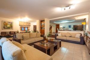 a large living room with couches and a table at Seaview Villa Cleopatra - Private Pool & Tennis Court in Kalamos