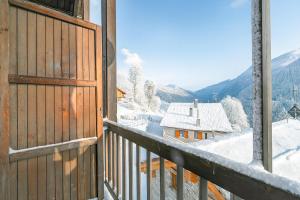 a view from a balcony with snow covered roofs at Champlas Suite - Happy Rentals in Sauze di Cesana