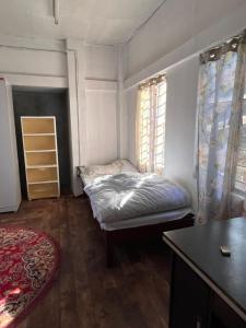 Ένα ή περισσότερα κρεβάτια σε δωμάτιο στο Keke homestay