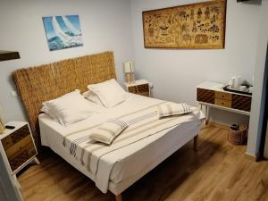 a bedroom with a bed with white sheets and white pillows at atmosphere in Poilhès