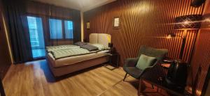 a living room with a couch and a chair at Pension Sonne in Baden-Baden