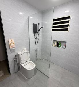 a bathroom with a toilet and a shower stall at Hatasan Homestay Guess House in Perai +25 photos