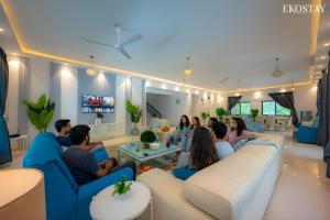 a group of people sitting on couches in a living room at Ekostay Luxe - CASA SIA - Ideal for Big Groups- Poker Table in Lonavala +31 photos