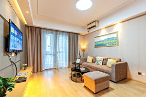 TV a/nebo společenská místnost v ubytování Guangzhou Efit International Apartment