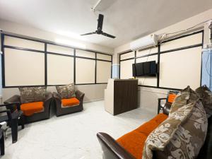 a living room with a couch and a flat screen tv at Sterlinge Homestay in Visakhapatnam +14 photos