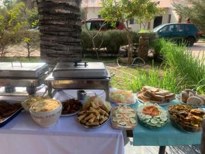 a table with a buffet of food on it at Georgianas Residence in Kartung
