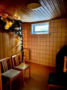 a room with two chairs and a window at Guesthouse Sahanpera in Rovaniemi +8 photos