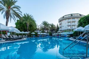 a swimming pool in front of a hotel at SİDE SUN in Manavgat