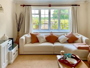 a living room with a couch and a window at Harbourside in Poole