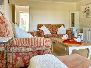 a living room with a couch and a table at Harbourside in Poole
