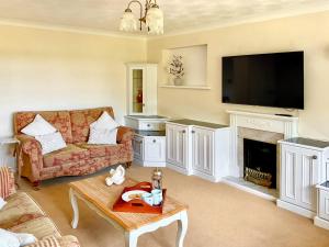 a living room with a couch and a fireplace at Harbourside in Poole +26 photos