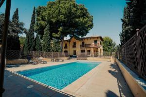 a swimming pool in front of a house at Casa Rural 5 Estrellas en Totana in Totana +38 photos