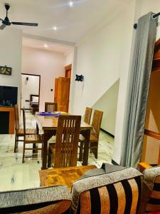 a dining room with a wooden table and chairs at Villa Mangrove Serenity in Galle +9 photos