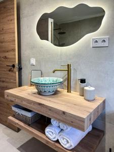 a bathroom with a counter with a sink and a mirror at Cuevas El Abanico - VTAR vivienda turística de alojamiento rural in Granada