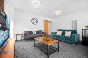 a living room with two couches and a table at 4 Bedroom Town House Perfect for families or contractors Sleeps 8 in Halesowen