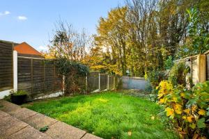 a backyard with a fence and green grass at 4 Bedroom Town House Perfect for families or contractors Sleeps 8 in Halesowen