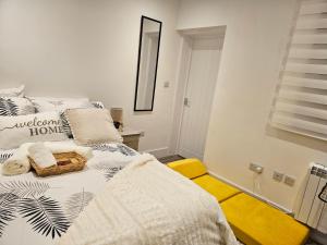 a white bedroom with a bed with a mirror at Entire Flat in heart of Oxford in Oxford