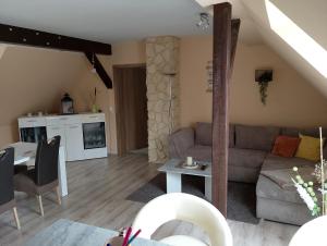 a living room with a couch and a table at Landhaus Waldblick in Kritzow +19 photos