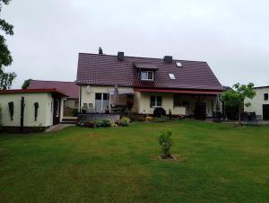 a house with a green lawn in front of it at Landhaus Waldblick in Kritzow