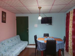 a dining room with a table and a couch at Beautiful air condioned villa for singles, couples, families and groups cozy stay in La Chorrera