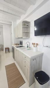a kitchen with a sink and a counter top at Idyllic Mykonos Suite w Jacuzzi and Sea Panorama in Houlakia