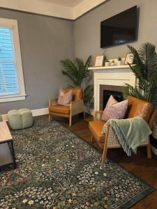 a living room with two chairs and a fireplace at Downtown, Updated, Single Story & WD in Columbus +33 photos