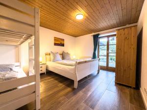 a bedroom with a bed and a window at Landhaus Steibis in Steibis