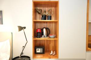 a wooden shelf with a coffee maker and a coffee pot at Rooftop Tirana in Tirana +18 photos