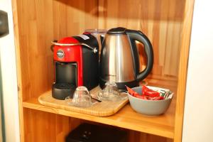 a coffee maker on a shelf in a cupboard at Rooftop Tirana in Tirana