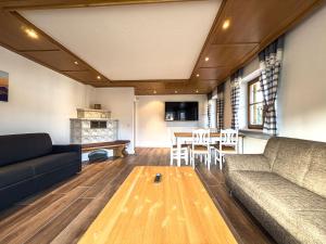 a living room with a couch and a table at Landhaus Steibis in Steibis