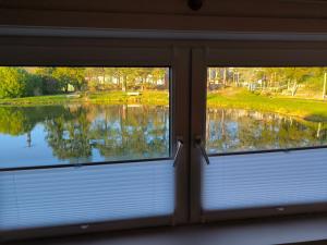 a view of a lake from a window at Schwanensee Ferienhaus in Göhren
