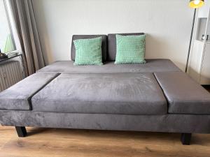 a bed with two pillows on it in a room at Strandhotel - 19 "Sardinenbüchse" in Dahme