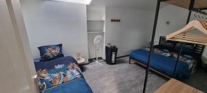 Un dormitorio con dos literas y un ventilador. en Maison proche Grand Parc 2 Chambres, en Mauléon