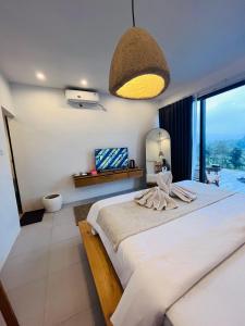 a bedroom with a large bed with a large window at Pinggan harmoni in Baturaja +31 photos