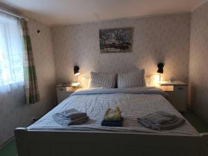 a bedroom with a large bed with towels on it at Room with Midnight-sun and Norhern-light View in Vestvågøya