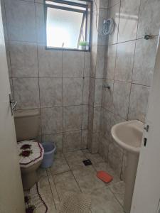 a bathroom with a shower and a toilet and a sink at Apartamento Larah in Cianorte