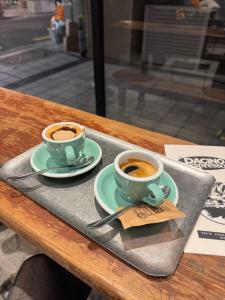 two cups of coffee on a tray on a table at 신사 여성전용 개인 미니룸 Female Only Private Mini Room Gosiwon 2pm ckeck in 11am ckeck out address 강남구 논현동6-8 BESTEL, Check the message for the check in in Seoul