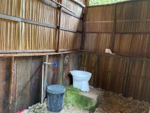 a bathroom with a toilet in a wooden wall at Mantorom homestay in Yennanas Besir